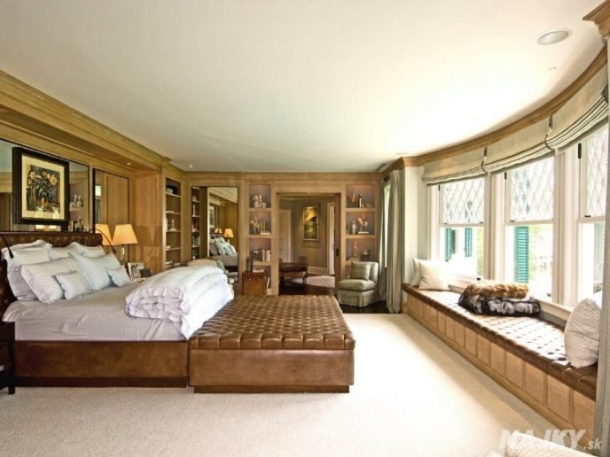 the-master-suite-has-a-large-bay-window-with-a-sweeping-view-of-the-verdant-property