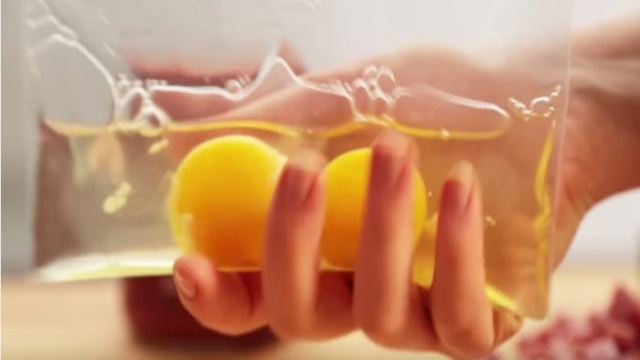 She puts 2 eggs in a ziploc bag and shows a unique way to cook breakfast.jpg