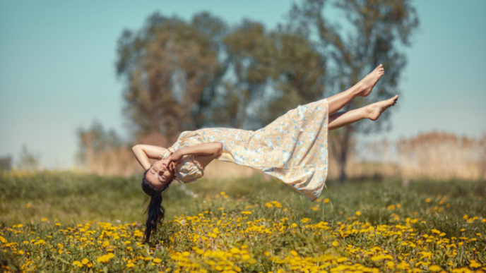 Girl hovers over the field.