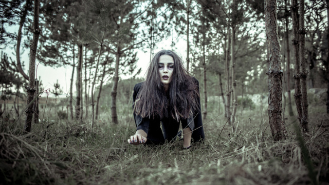 Girl with scary makeup in the forest