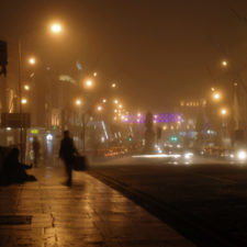 Solitary figure on bridge in Cork by night, Ireland