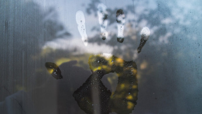 Hand print on hazy glass in the morning