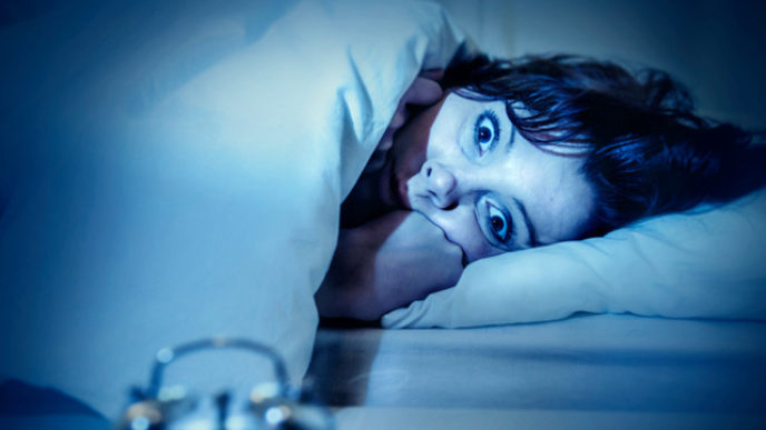 Woman in bed eyes opened suffering insomnia and sleep disorder