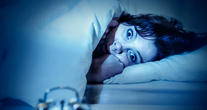 Woman in bed eyes opened suffering insomnia and sleep disorder
