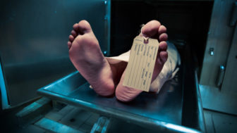 Feet on a morgue table with toe tag