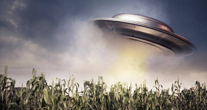 UFO hovering over a crop field
