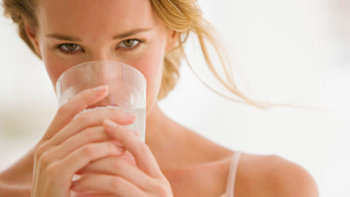 Woman holding glass of water