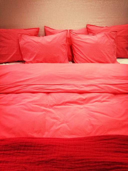 Bed with red romantic bed linen