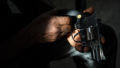Hands holding the gun