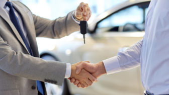 Close up of handshake in auto show or salon