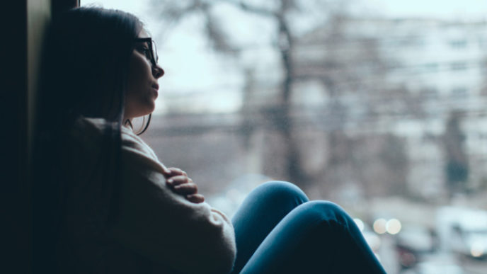 Teenage girl looking out the window