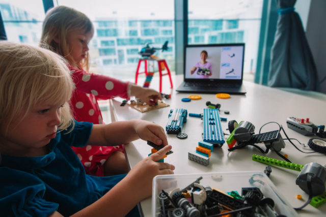 Kids building robot with online robotic technology lesson