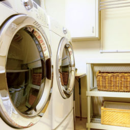 Old style laundry room with modern appliances and wicker baskets
