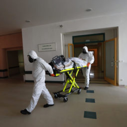 Health care workers transport a COVID-19 patient from an intensive care unit (ICU) at a hospital in Kyjov to hospital in Brno, Czech Republic, Thursday, Oct. 22, 2020. With cases surging in central Europe, some countries are calling in soldiers, firefighters, students and retired doctors to help shore up buckling health care systems. Many faced a shortage of medical personnel even before the pandemic, and now the virus has sickened many health workers, compounding the shortfall.