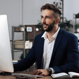 Man working on computer at table in office