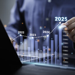 Businessman analyzes the graph of trend market growth in 2025 and plans business growth and profit increase in the year 2025. plan finances of the business