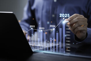 Businessman analyzes the graph of trend market growth in 2025 and plans business growth and profit increase in the year 2025. plan finances of the business