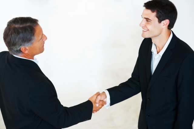 High angle view of business colleagues shaking hands