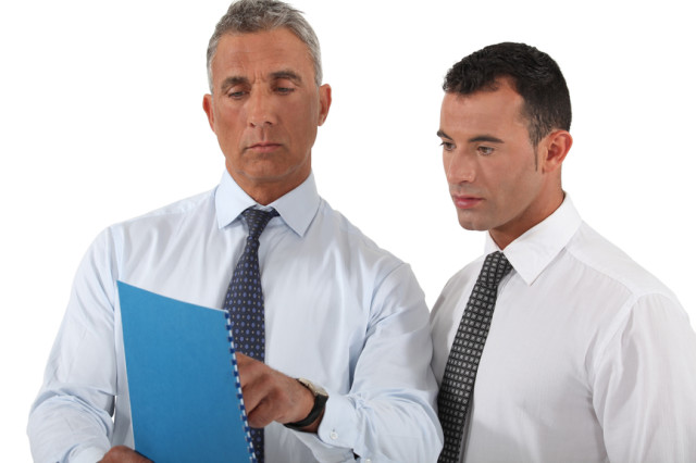 businessman showing a report to a colleague