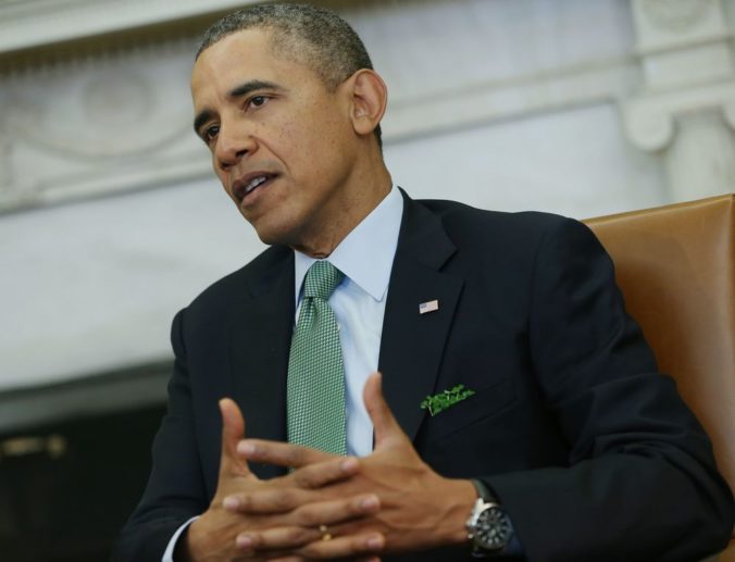 President Barack Obama, wearing a green tie and with shamrock in the breast pocket of his suit, makes a statement to reporters during his meeting with Irish Prime Minister Enda Kenny in the Oval Office of the White House in Washington, Friday, March 14, 2014. (AP Photo/Pablo Martinez Monsivais)