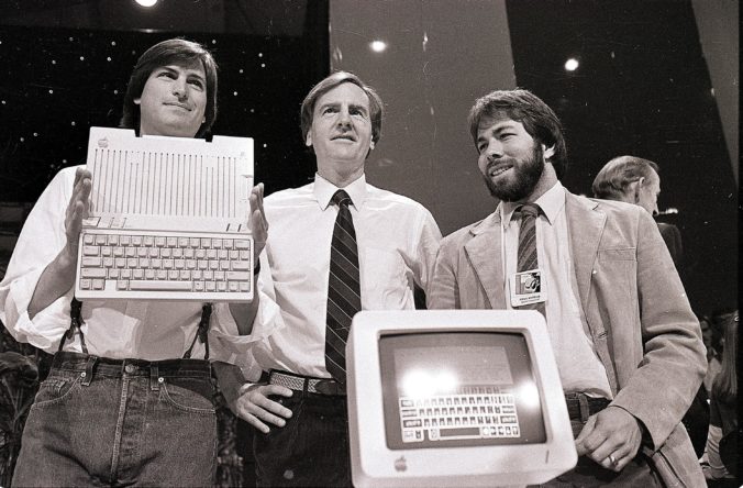 FILE - In this April 24, 1984, file photo, from left, Steve Jobs, chairman of Apple Computers, John Sculley, president and CEO, and Steve Wozniak, co-founder of Apple, unveil the new Apple IIc computer in San Francisco. Apple on Wednesday, Oct. 5, 2011 said Jobs has died. He was 56. (AP Photo/Sal Veder, File)