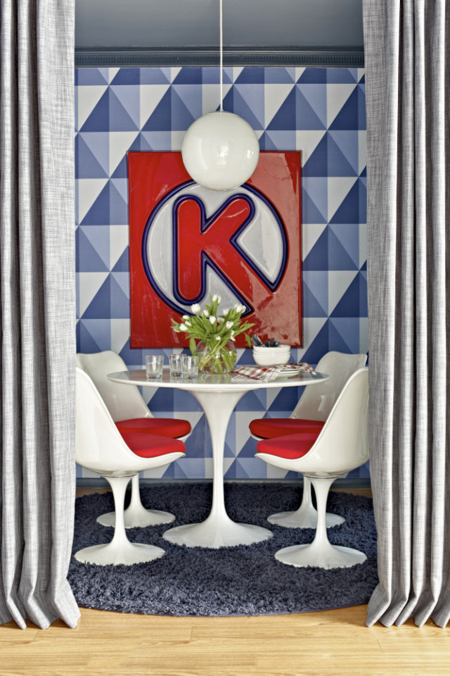 This publicity photo provided by Brian Patrick Flynn shows a tiny breakfast nook designed by Brian Patrick Flynn for his Hollywood Hills weekend home. Flynn used a modern, nautical Cole & Sons wallpaper with a casual feel, then added accents of red through Saarinen tulip chairs and a vintage Circle K sign found at the Rose Bowl Flea Market. Like the best flea market finds, the Circle K sign connects with the homeowner's past (in this case, teen years growing up near Florida beaches), giving his weekend home a personal, nostalgic feel. (AP Photo/Brian Patrick Flynn, Daniel Collopy)