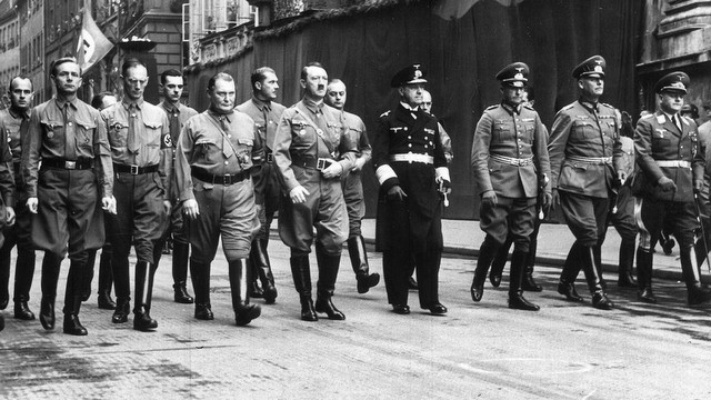FILE - This Nov. 9, 1938 file photo shows German leader Adolf Hitler, center, with Hermann Goering, center left, and other Nazi commanders marching through Munich. In Munich, Hitler launched his political career with speeches condemning Jews and proclaiming the ethnic superiority of Germans. (AP Photo, File)
