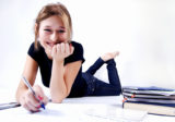 young happy female student studying diligently