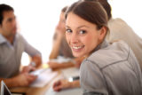 Portrait of smiling working girl in meeting