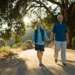 Mature couple walking down dirt road