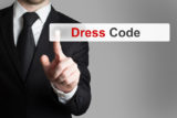 businessman in office pushing touchscreen button dress code