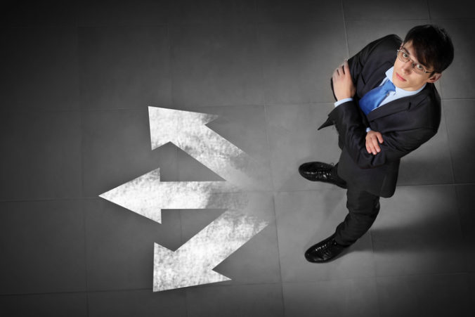 Top view of businessman standing against directions background