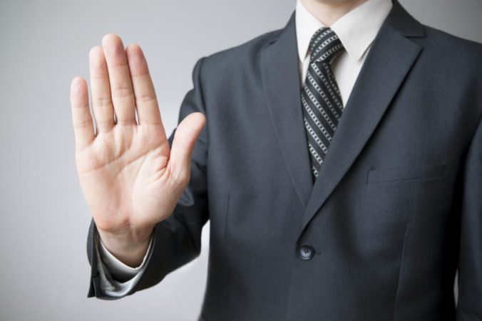 Businessman gesture with his hands on gray background