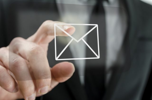 Businessman touching email icon