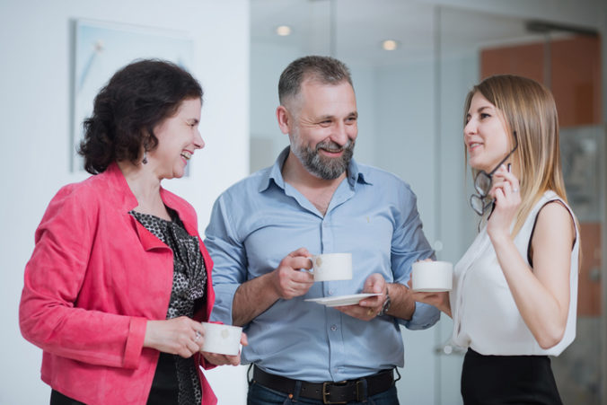 Colleagues in the office talking during the coffee break