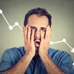 Frustrated stressed man desperate with financial market graphic going down