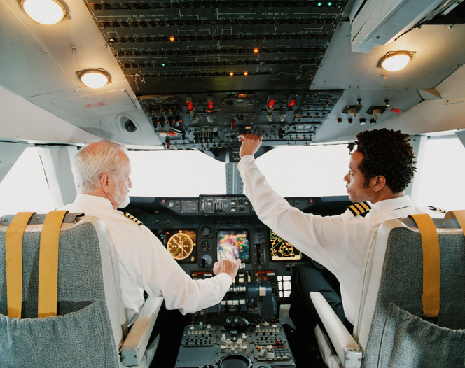 Portrait of Pilots Sitting in the Cockpit, Adjusting the Controls