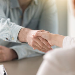 Business agreement handshake of man and woman at the office