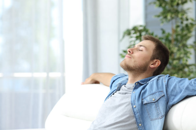 Man resting on a couch at home