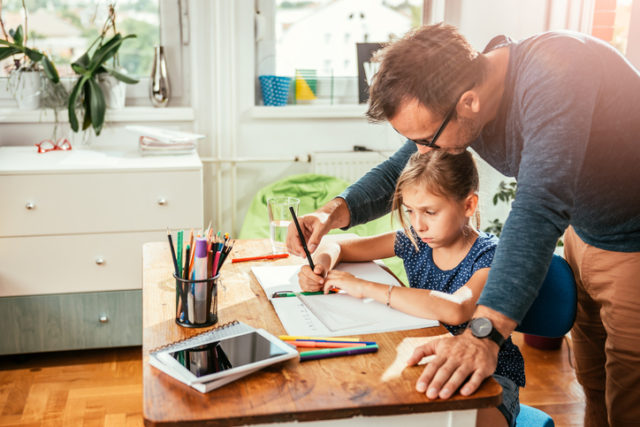 Rodič pomáhajúci dieťaťu s domácou úlohou