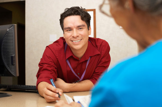 Man helping woman with paperwork