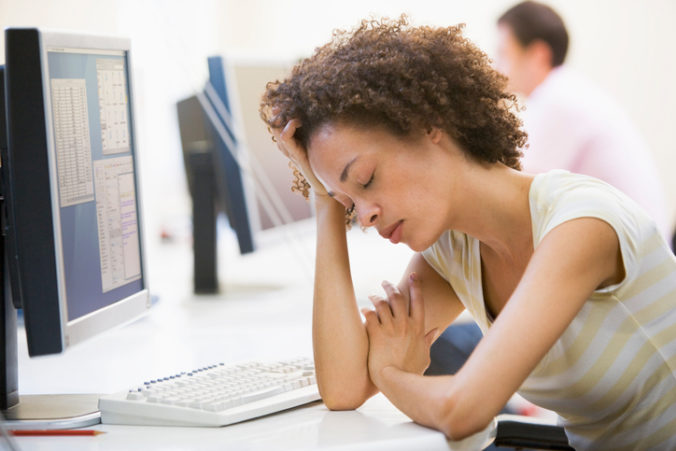 Woman in computer room sleeping