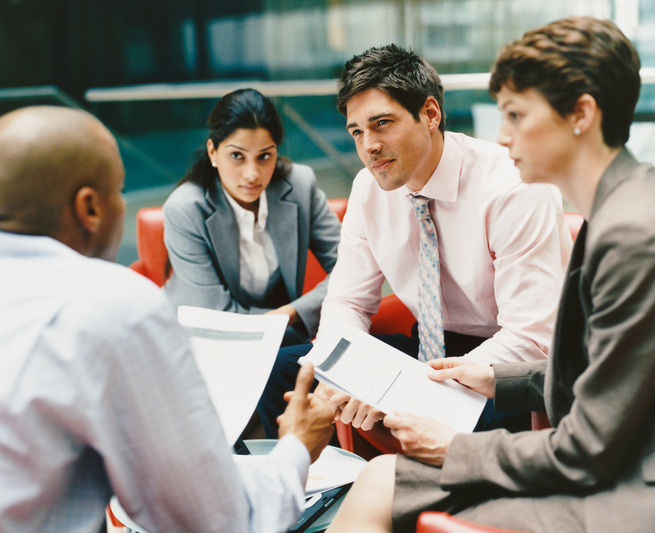 Business People Sitting in an Office Building Having a Meeting