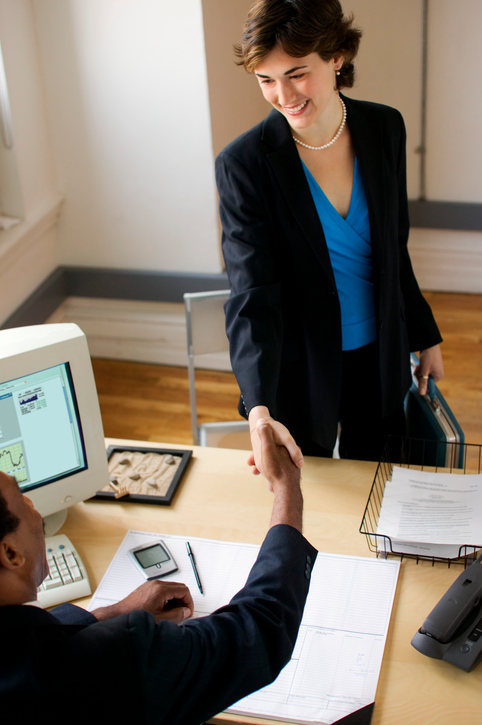 Businessman and businesswoman shaking hands