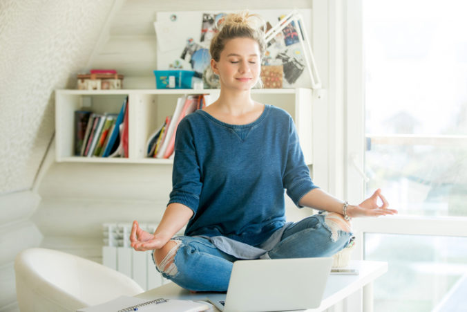 Portrait of an attractive woman at table , lotus pose