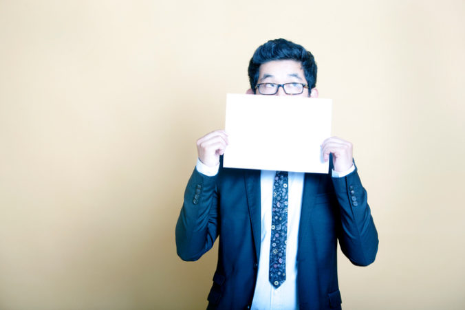 Businessman holding white blank sign