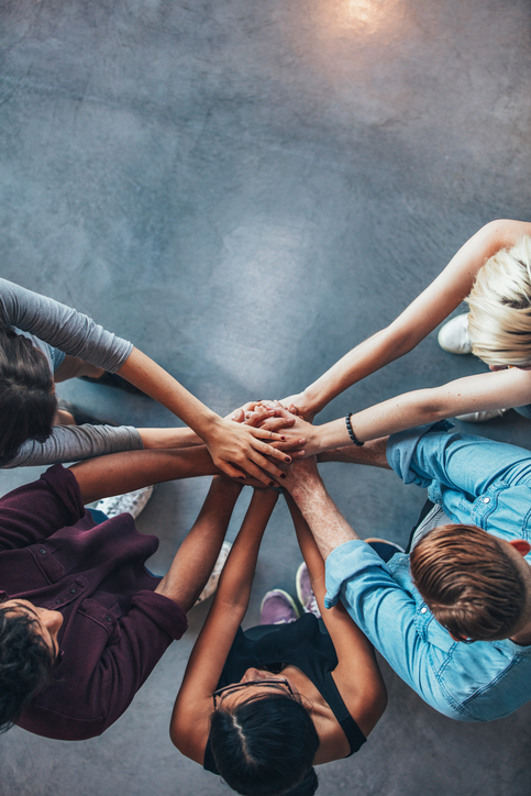 Stack of hands symbolizing trust and cooperation