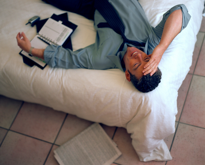 Businessman relaxing on bed