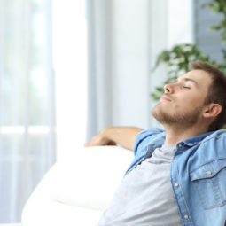 Man resting on a couch at home