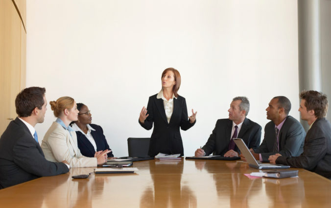 Businesswoman leading meeting in conference room